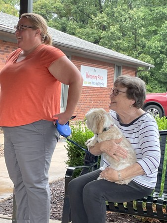 A lady holding a dog