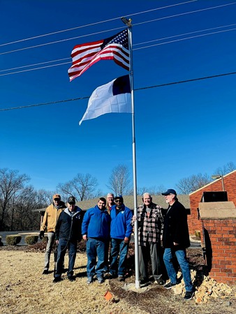 Planting a flagpole outside the church